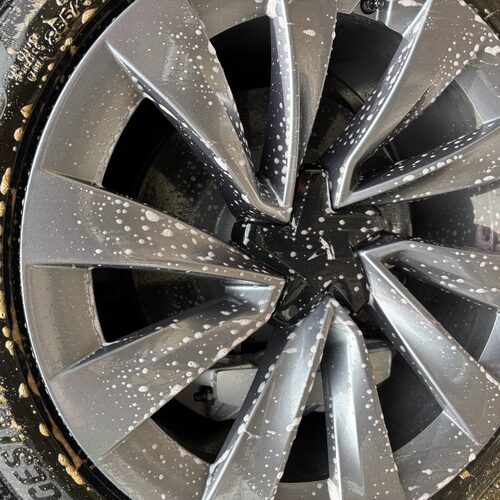 Wheel and tire being hand-washed during a Gospel Detailing service